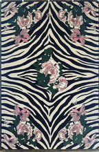 Load image into Gallery viewer, Hand-tufted rug with a black and white zebra pattern and pink floral design, accented with green leaves. Made from 100% New Zealand wool and fine viscose. Measures 6&#39; x 9&#39;.
