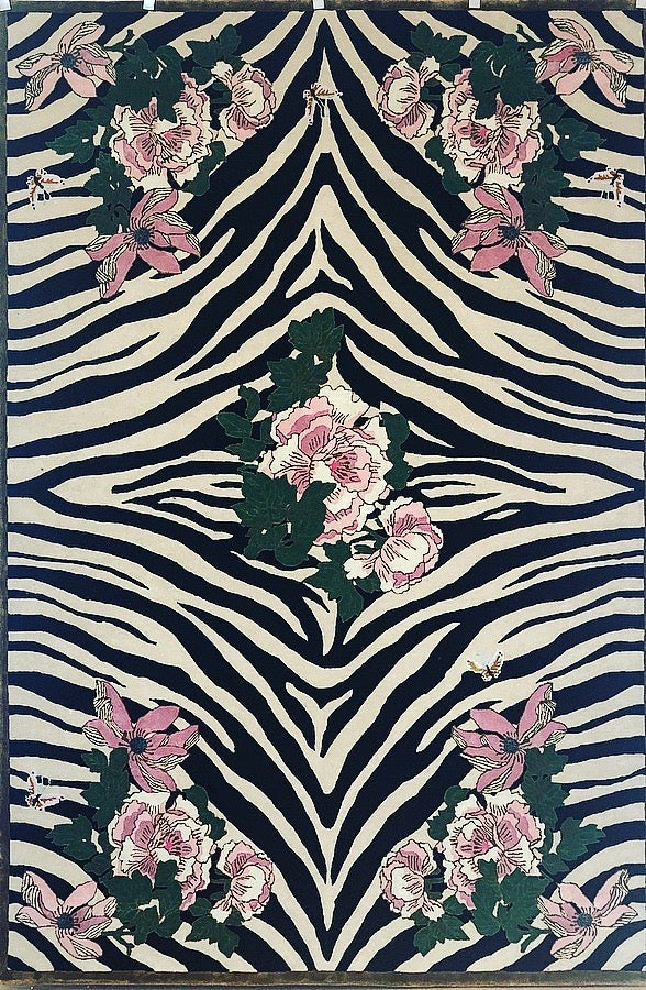 Hand-tufted rug with a black and white zebra pattern and pink floral design, accented with green leaves. Made from 100% New Zealand wool and fine viscose. Measures 6' x 9'.