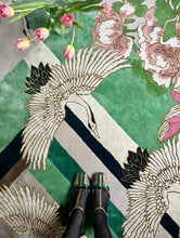 Load image into Gallery viewer, Hand-tufted rug with cranes and pink flowers on a green and pink geometric background, accented with viscose. Measures 6&#39; x 9&#39;
