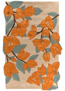 Hand-tufted rug with an uneven rectangular shape, featuring a floral design with bold orange flowers and green leaves on a beige background. Made from 100% New Zealand wool. Measures 6x9